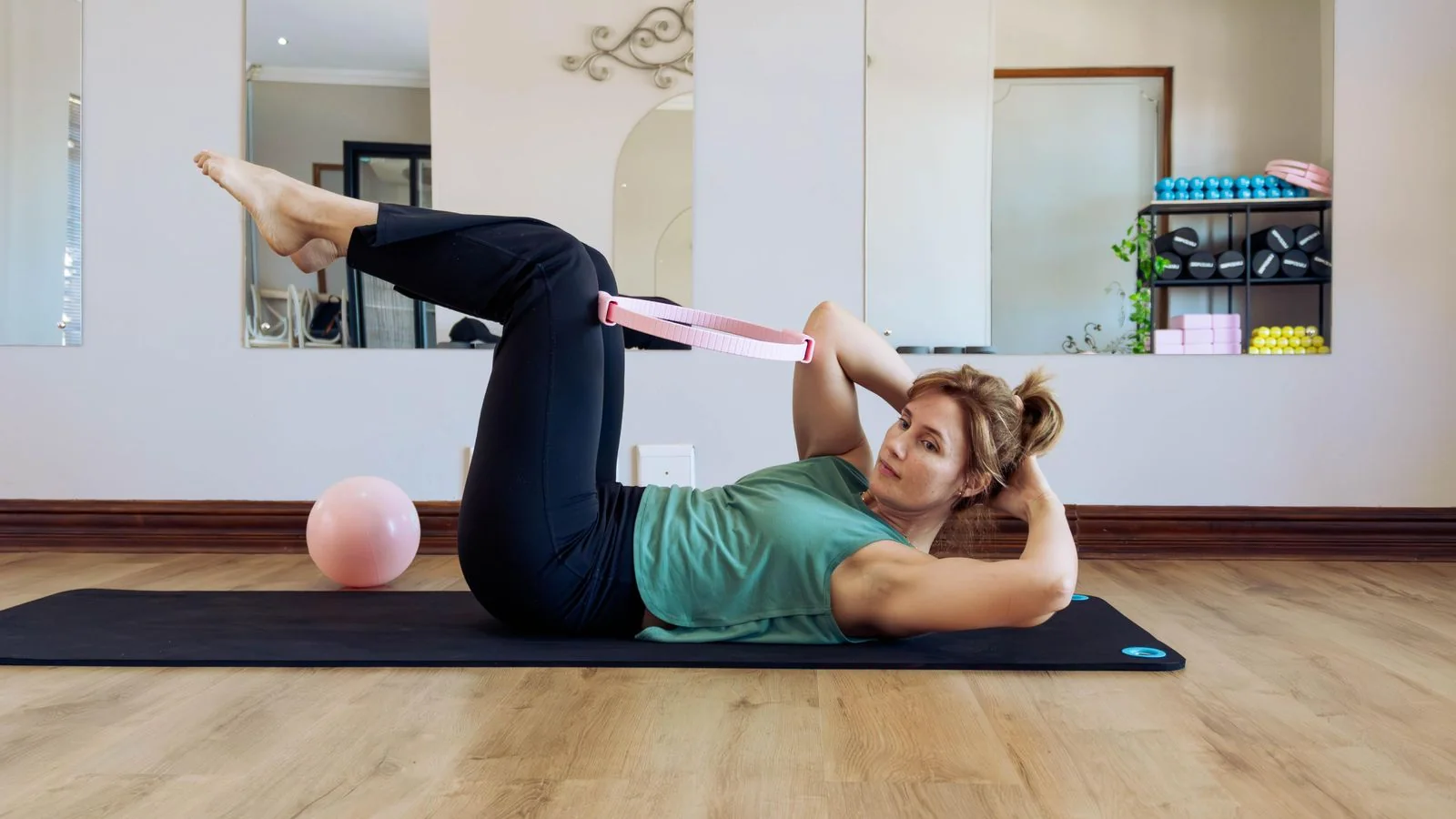 Anecia demonstrating a Pilates exercise
